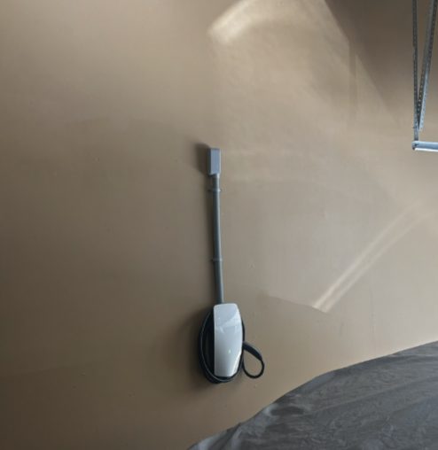 Level 2 EV charger installed on a garage wall by Fogle & Sons Electric