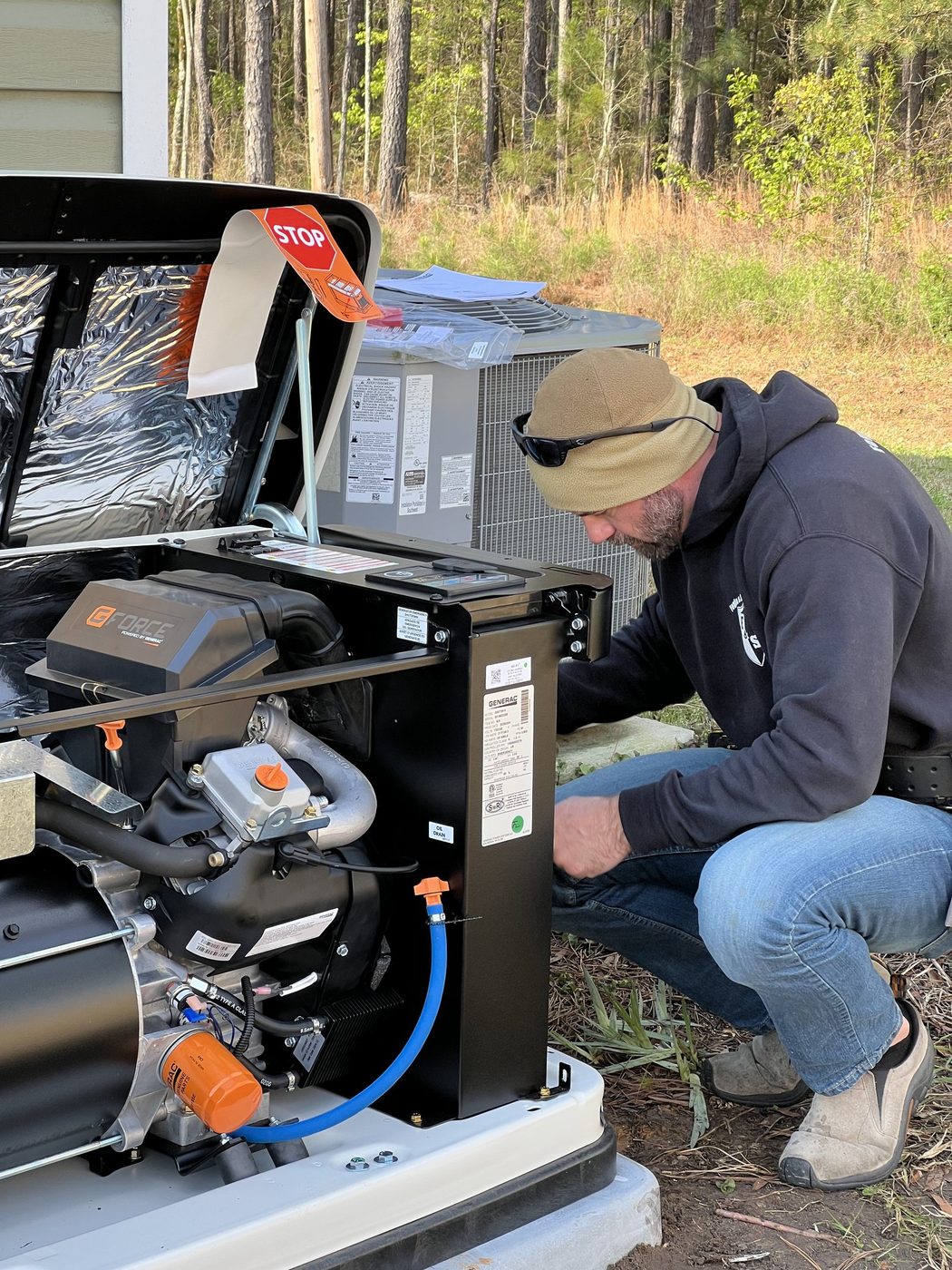 Fogle & Sons Electric technician installing a Generac standby generator